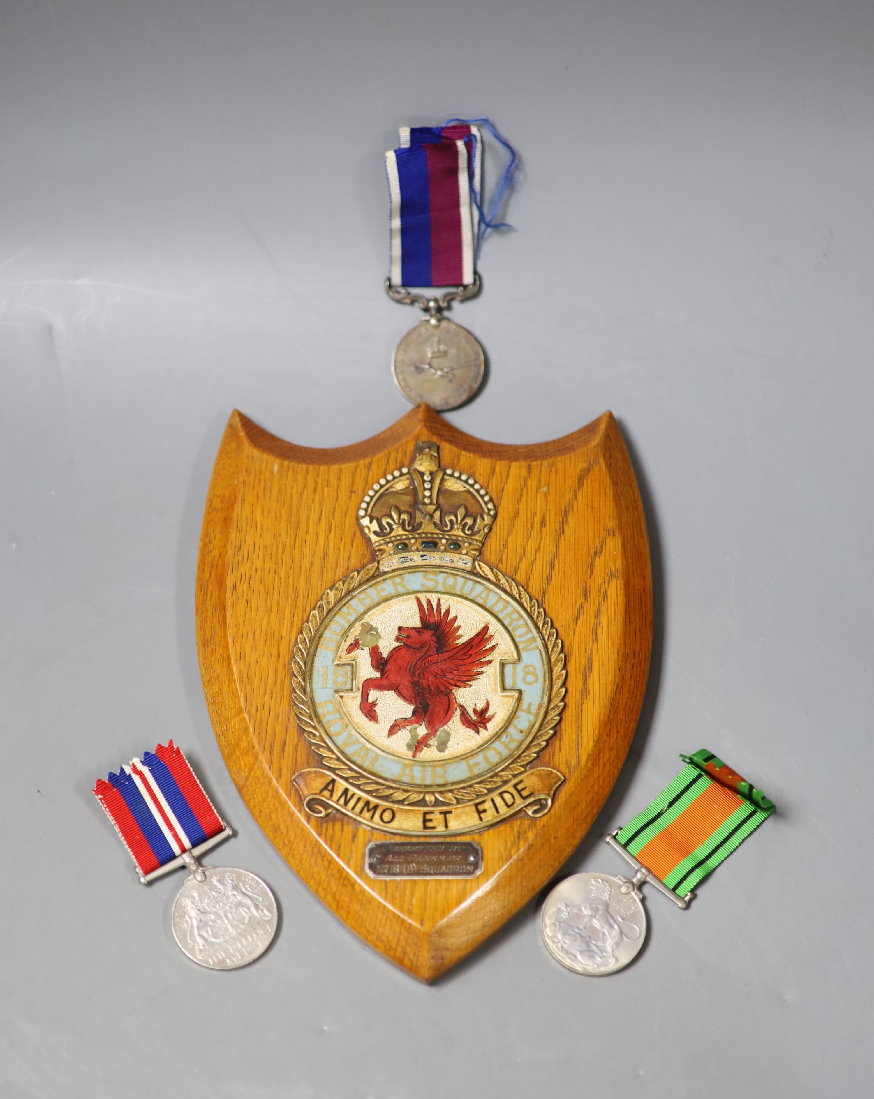 A group of three medals to Flight Sergeant H V Walder RAF 329595 including a George V RAF long service and good conduct medal and an RAF plaque, presented by all ranks of no.18 (B) squadron